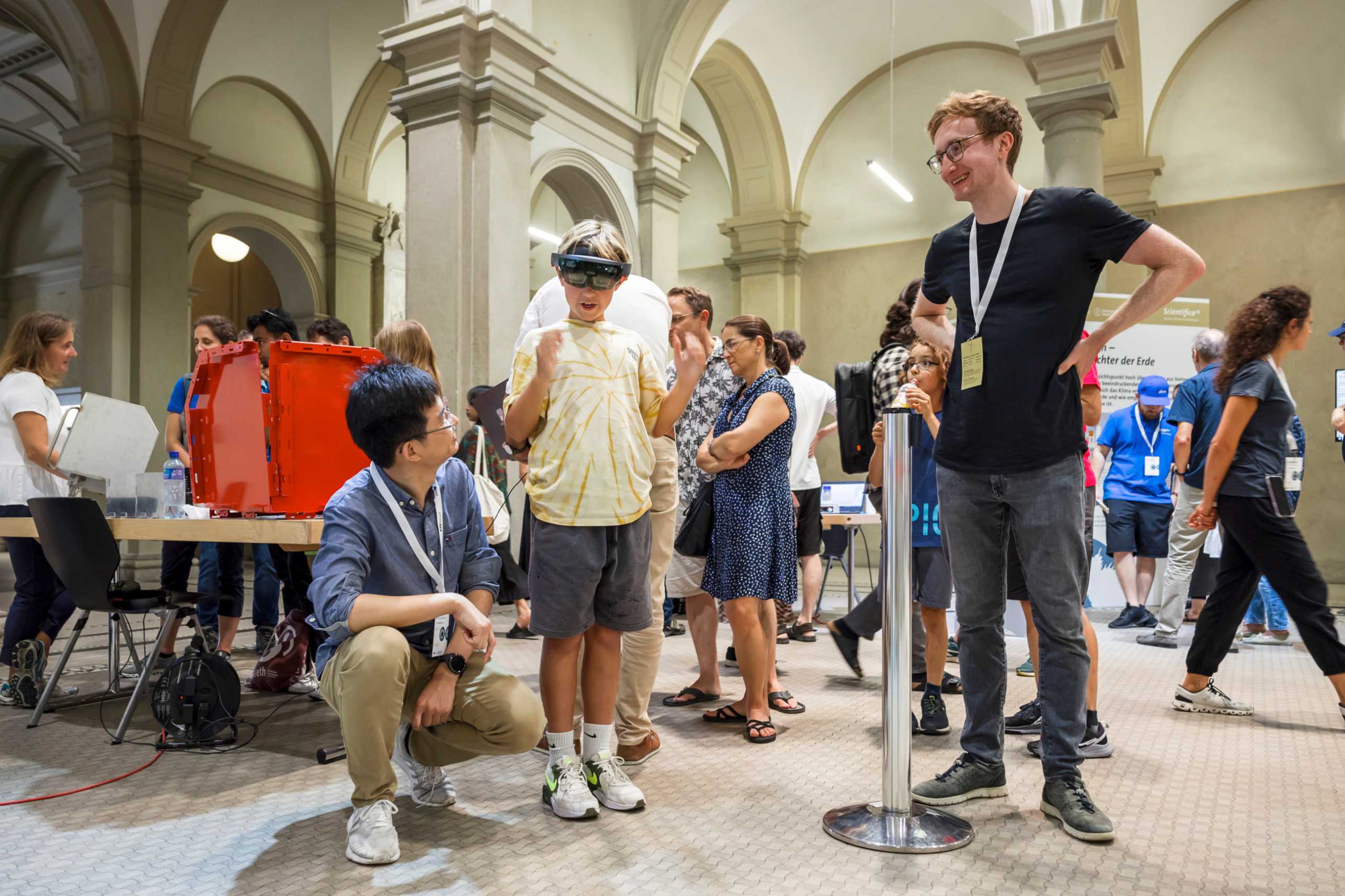 Enlarged view: Visitor of Scientifica 2023 trying out the SAR2 app on Microsoft Hololens with help of Shiyi Li and Marcel Stefko.